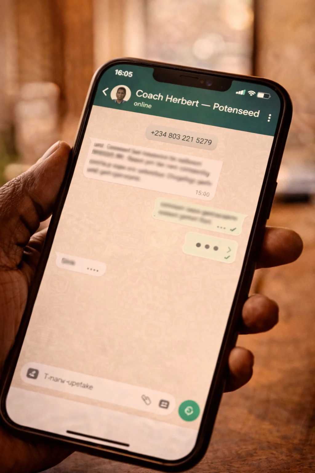Phone showing WhatsApp chat with Coach Herbert