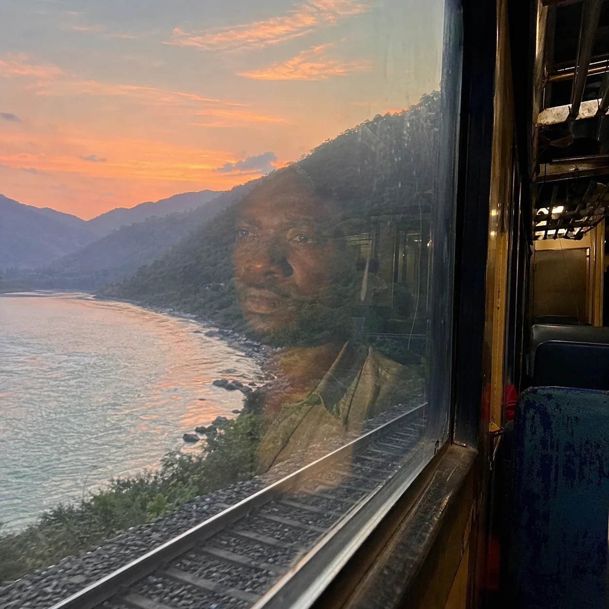 Train window heading north to Rishikesh at sunrise