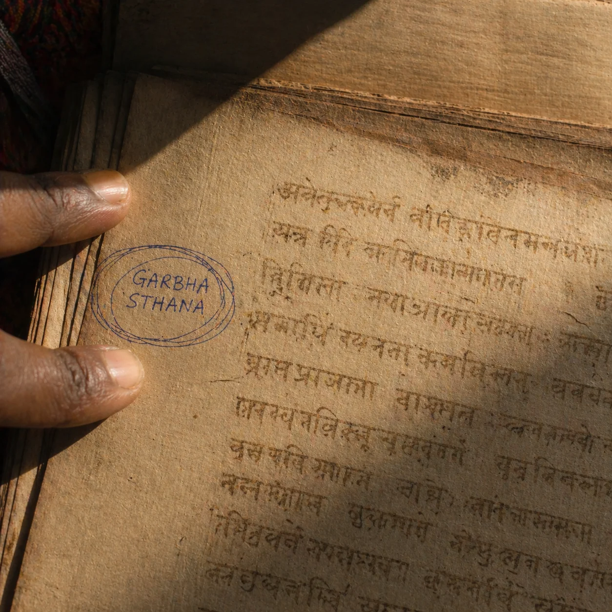 Yellowed palm leaf manuscript, GARBHA STHANA circled in blue ballpoint
