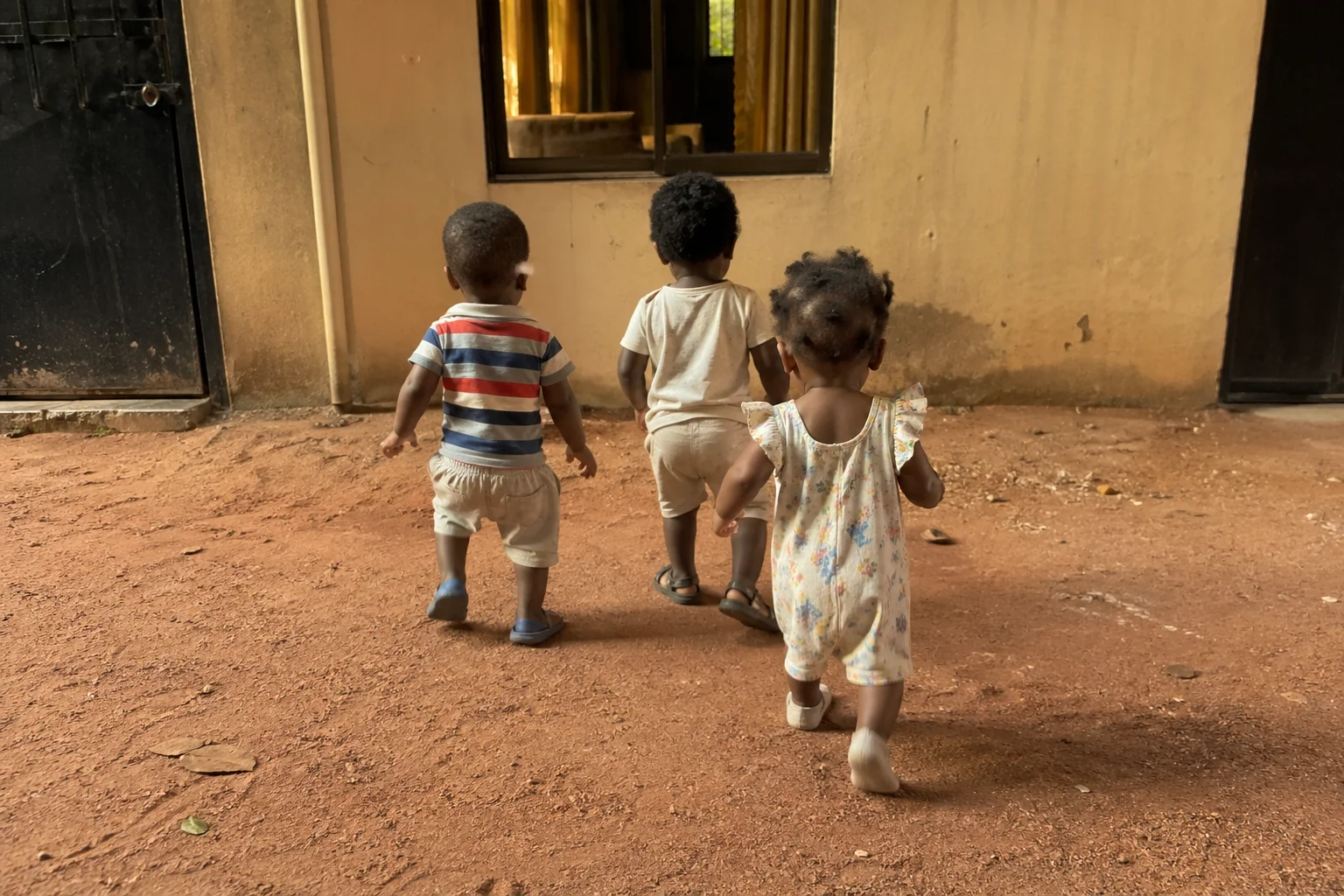 Triplets walking toward the window